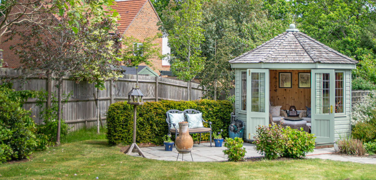 A view of the octagonal summerhouse from a distance to show the beautiful garden that surrounds the summerhouse