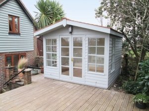 A large Blakeney Summerhouse with a chalet-style look due to its double doors and apex roof with slight overhang. 