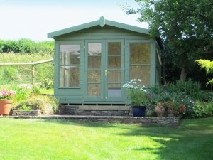 A traditional chalet-style Blakeney summerhouse with an apex roof and interior lining, insulation and electrical pack. 