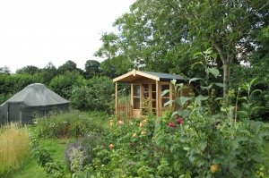 2.4 x 3.6m Morston Summerhouse treated with a Light Oak Preservative with veranda and attractive roof overhang