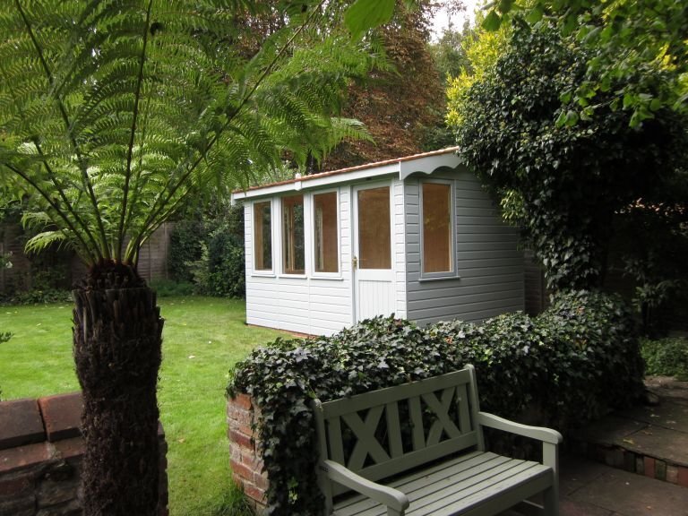 2.4 x 3.6m Langham Studio painted in Exterior Verdigris with cedar shingles on the roof