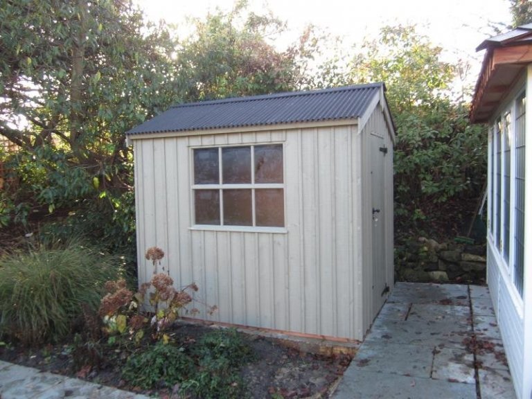 A garden shed from our national trust range, featuring vertically-sawn, rustic cut cladding and corrugated material on the roof. It is a traditional garden shed from our range of national trust sheds and summerhouses. It is also a shed with cast iron door furniture. 