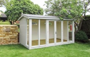 A beautiful garden studio with seven fully-glazed windows and an apex roof covered in slate-composite tiles. The interior is visible through the windows and features painted lining and a lacquered floor. 