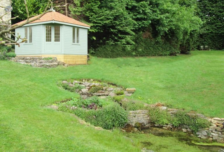 3.6 x 3.6m Weybourne Summerhouse painted in Exterior Lizard with leaded windows