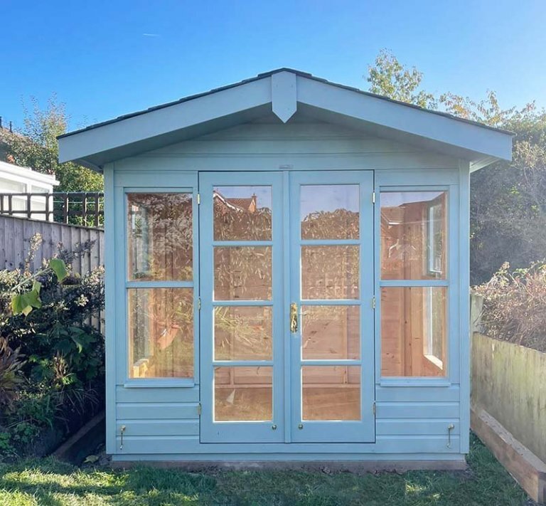 2.4 x 1.8m Blakeney Summerhouse painted in Exterior Verdigris with apex roof design and smooth shiplap cladding