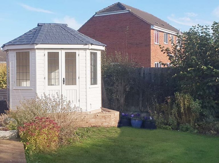 2.4 x 3.0m Wiveton Summerhouse painted in Farrow & Ball Wimborne White with leaded windows